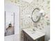 Bathroom view shows vanity, mirror, lighting, tiled flooring and open doorway at 2700 Bayshore Blvd # 3210, Dunedin, FL 34698