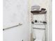 Cozy bathroom featuring a wallpaper design and storage shelf for towels above the toilet at 2700 Bayshore Blvd # 3210, Dunedin, FL 34698