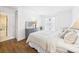 Cozy bedroom with wood-look flooring, dresser, and view into bathroom for convenience at 2700 Bayshore Blvd # 3210, Dunedin, FL 34698