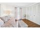 Bedroom with wood-look floors, daybed, accent table, and natural light from the window at 2700 Bayshore Blvd # 3210, Dunedin, FL 34698