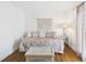 Bedroom with wood-look floors, daybed, accent table, and natural light from the window at 2700 Bayshore Blvd # 3210, Dunedin, FL 34698