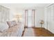 Bedroom with wood-look floors, daybed, accent table, and natural light from the window at 2700 Bayshore Blvd # 3210, Dunedin, FL 34698