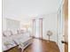 Bedroom with wood-look floors, daybed, accent table, and natural light from the window at 2700 Bayshore Blvd # 3210, Dunedin, FL 34698