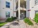Building exterior with elevator access, landscaping, and a well-maintained pathway, enhancing accessibility and appeal at 2700 Bayshore Blvd # 3210, Dunedin, FL 34698
