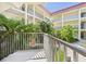 Balcony view overlooking a vibrant courtyard, blending indoor comfort with outdoor beauty and relaxation at 2700 Bayshore Blvd # 3210, Dunedin, FL 34698