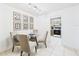 Dining room with a glass table, four chairs and decorative wall art at 2700 Bayshore Blvd # 3210, Dunedin, FL 34698