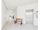 Hallway with bench seat and elevator access, neutral color scheme throughout at 2700 Bayshore Blvd # 3210, Dunedin, FL 34698