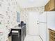 Compact kitchen with tile flooring and retro wallpaper, featuring a serving counter at 2700 Bayshore Blvd # 3210, Dunedin, FL 34698