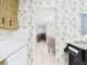 View from kitchen, showcasing floral wallpaper, tile flooring, and open layout into the dining room at 2700 Bayshore Blvd # 3210, Dunedin, FL 34698