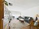 Inviting living room featuring a plush gray sofa, decorative plants and carpet at 2700 Bayshore Blvd # 3210, Dunedin, FL 34698