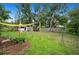 Spacious backyard featuring a shade structure, well-maintained lawn, and ample room for outdoor activities and enjoyment at 1007 N Wheeler St, Plant City, FL 33563
