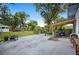 Backyard with a stone patio, pergola, grill, and views of mature trees at 1007 N Wheeler St, Plant City, FL 33563