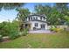 Spacious backyard with a patio, pergola, lush landscaping, and a well-maintained lawn at 1007 N Wheeler St, Plant City, FL 33563