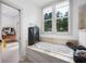 Bathroom with a large soaking tub, natural light from the window, and neutral stone detail at 1007 N Wheeler St, Plant City, FL 33563