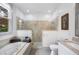 Bright bathroom featuring a glass shower, soaking tub, and granite countertop vanity with natural light at 1007 N Wheeler St, Plant City, FL 33563