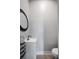 Neutral powder room featuring a modern sink vanity with round mirror and sleek fixtures at 1007 N Wheeler St, Plant City, FL 33563