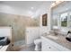 Modern bathroom featuring a glass shower, granite countertop vanity, and stylish neutral decor at 1007 N Wheeler St, Plant City, FL 33563