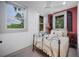 Cozy bedroom with large windows providing lots of natural light and stylish iron bed frame at 1007 N Wheeler St, Plant City, FL 33563