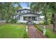 Two-story home with inviting front porch, red door, and well-manicured landscaping at 1007 N Wheeler St, Plant City, FL 33563