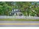 Charming two-story home with a white picket fence and mature trees at 1007 N Wheeler St, Plant City, FL 33563