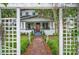 Beautiful two-story home with a red brick walkway through a white pergola at 1007 N Wheeler St, Plant City, FL 33563