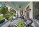 Inviting front porch with seating, patterned floor, and stylish decor at 1007 N Wheeler St, Plant City, FL 33563