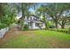 Two-story home with lush front yard and mature trees providing shade at 1007 N Wheeler St, Plant City, FL 33563