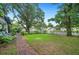 Well-maintained front yard with pergola, white picket fence, and brick walkway at 1007 N Wheeler St, Plant City, FL 33563