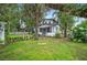 Two-story home with charming front yard, swing, and lush landscaping at 1007 N Wheeler St, Plant City, FL 33563