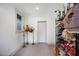 Bright hallway featuring three vintage lamps and shelving with vintage lampshades at 1007 N Wheeler St, Plant City, FL 33563