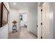 Hallway area with light wood flooring and an open view to a sun-filled room at 1007 N Wheeler St, Plant City, FL 33563