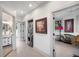 Hallway featuring modern stacked washer/dryer, bathroom, and view into the living room at 1007 N Wheeler St, Plant City, FL 33563