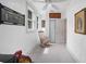 Hallway featuring three windows, wood floors, and neutral decor with vintage rocking chair at 1007 N Wheeler St, Plant City, FL 33563