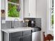 Close up on the kitchen sink and faucet with granite countertops and gray backsplash tiles at 1007 N Wheeler St, Plant City, FL 33563