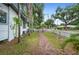 Side yard with a brick path and white picket fence, offering a charming and private outdoor space at 1007 N Wheeler St, Plant City, FL 33563