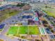 Aerial view of community center with pool, lawn bowling, clubhouse and parking at 1735 Council Dr, Sun City Center, FL 33573