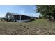 Exterior of home featuring a large screened in back porch and spacious yard at 1735 Council Dr, Sun City Center, FL 33573