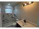 Stylish bathroom with modern vanity, updated fixtures, and a tiled shower at 1735 Council Dr, Sun City Center, FL 33573