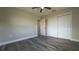 Comfortable bedroom featuring modern flooring, neutral paint, ceiling fan, and natural light at 1735 Council Dr, Sun City Center, FL 33573
