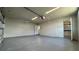 Well lit garage with door to kitchen and additional storage space at 1735 Council Dr, Sun City Center, FL 33573