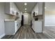 Modern kitchen boasting white cabinets, black hardware, sleek countertops, and stainless steel appliances at 1735 Council Dr, Sun City Center, FL 33573
