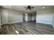 Open living area featuring modern flooring, neutral paint, ceiling fan, and ample natural light at 1735 Council Dr, Sun City Center, FL 33573