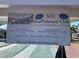 Community shuffleboard sign with information on winter and summer hours at 1735 Council Dr, Sun City Center, FL 33573