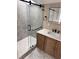 Sleek bathroom boasts a glass enclosed shower with a modern wood vanity at 3620 E Tampa Cir, Tampa, FL 33629