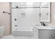 Updated bathroom with white subway tile and decorative tile accents, including a shower and tub combo at 3620 E Tampa Cir, Tampa, FL 33629
