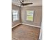 Bright bedroom with a ceiling fan and great natural light from two windows at 3620 E Tampa Cir, Tampa, FL 33629