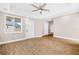 Bedroom featuring ceiling fan, window, and a door leading to the outside at 3620 E Tampa Cir, Tampa, FL 33629
