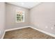 Bright bedroom showcasing laminate floors, a window, and neutral paint for a modern appeal at 3620 E Tampa Cir, Tampa, FL 33629
