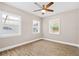 This bedroom is filled with natural light and has a ceiling fan for added comfort at 3620 E Tampa Cir, Tampa, FL 33629