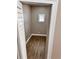 A tan interior closet with a small window and wood-look floors provides storage at 3620 E Tampa Cir, Tampa, FL 33629